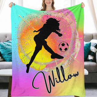 a woman holding a colorful blanket with a soccer ball