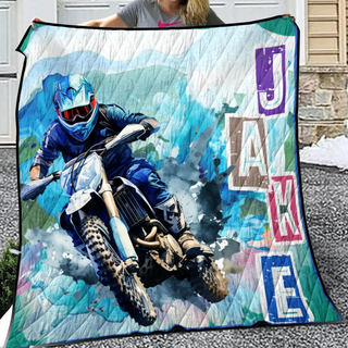 a woman holding a blanket with a picture of a motorcyclist on it