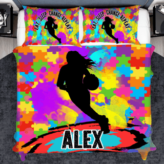 a bed with a colorful comforter with a basketball player on it