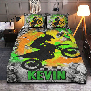 a bed with a green and yellow cover with a picture of a person on a