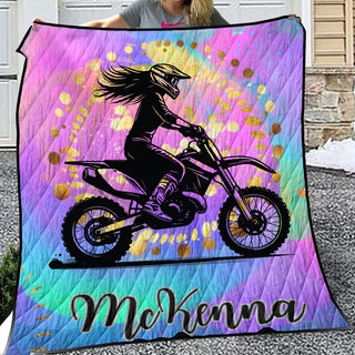 a woman holding up a colorful motorcycle blanket