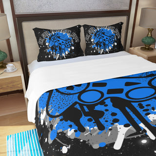 a bed with a blue and black comforter and two pillows