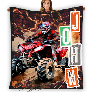 a woman holding up a large blanket with a picture of a person on a quad