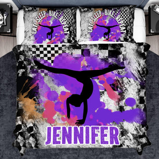 a bed covered in a purple and black comforter