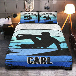 a bed with a blue and black surfboard comforter