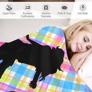 a woman laying in bed under a blanket with a dog on it