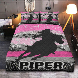 a bed covered in a pink and black quilt