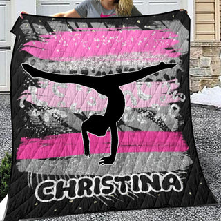 a woman holding up a pink and black blanket