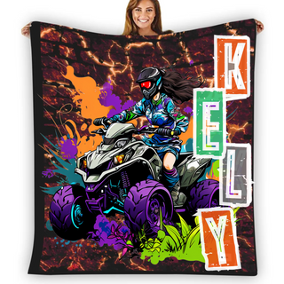 a woman holding up a blanket with a picture of a person on a four wheeler