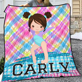 a girl holding up a colorful blanket with a picture of a girl on it