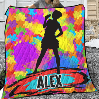 a woman holding up a colorful blanket with a picture of a woman on it