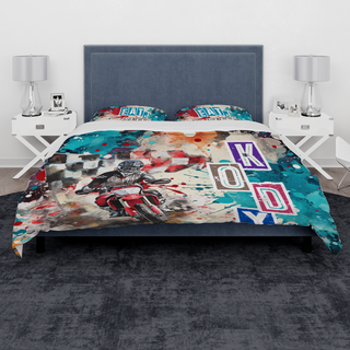 a bed with a motorcycle themed comforter and pillows