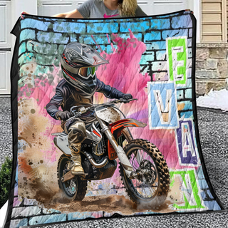 a woman holding a blanket with a picture of a dirt bike rider on it