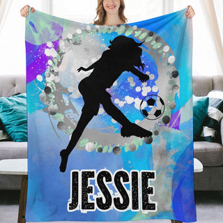 a woman holding a soccer themed personalized blanket