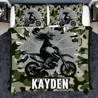 a bed with a camouflage print and a girl on a motorbike