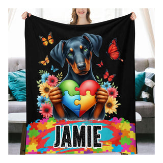 a woman holding a blanket with a dog holding a puzzle