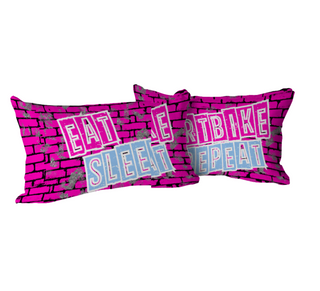 a pair of pink pillows with words on them