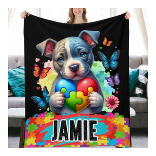 a woman holding a blanket with a dog holding a puzzle