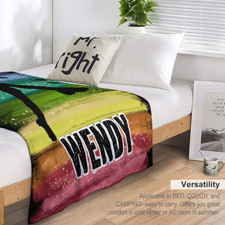 a bed with a colorful blanket on top of it