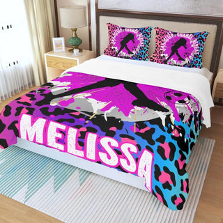 a bed with a pink, blue, and black design on it