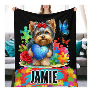 a woman holding a blanket with a dog on it