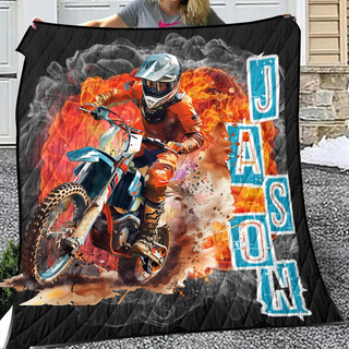 a woman holding a blanket with a picture of a dirt bike rider