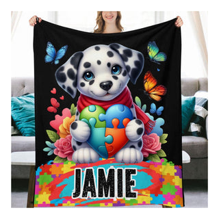 a woman holding a black blanket with a dalmatian puppy on it