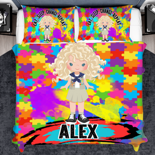 a bed with a colorful bed cover with a picture of a blonde girl on it