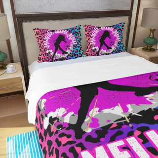 a bed with a pink and black bed spread