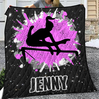 a woman holding up a black and pink blanket