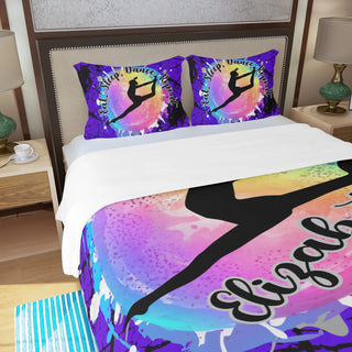 a bed with a colorful comforter and two pillows