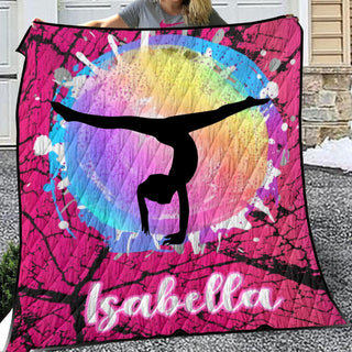 a woman holding up a colorful blanket with a woman doing a handstand