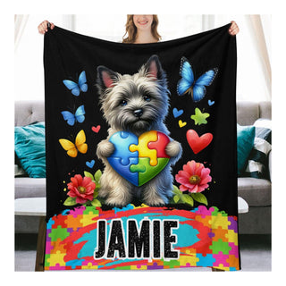 a woman holding a blanket with a dog on it