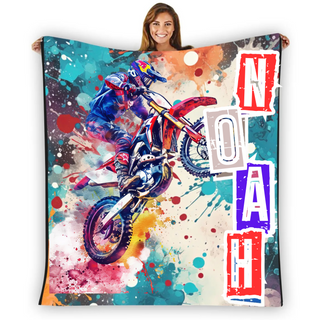 a woman holding a blanket with a picture of a dirt bike