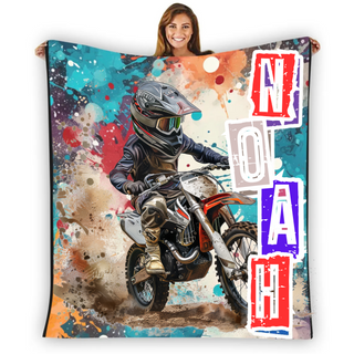 a woman is holding a blanket with a picture of a motorcyclist