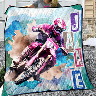 a woman holding a blanket with a picture of a dirt bike rider