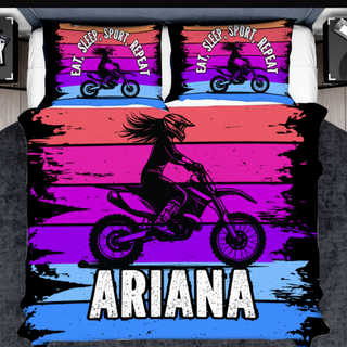 a bed cover with a girl on a dirt bike