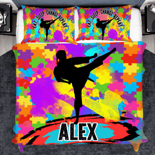 a bed with a colorful bed cover with a picture of a person doing a kick