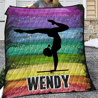 a woman is holding up a colorful quilt