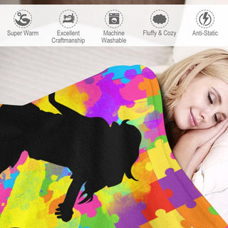 a woman laying in bed under a colorful blanket