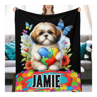 a woman holding a blanket with a dog on it