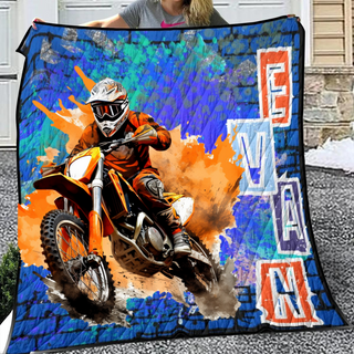 a woman holding a blanket with a picture of a dirt bike rider