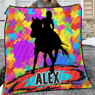 a woman holding a colorful blanket with a horse and rider on it