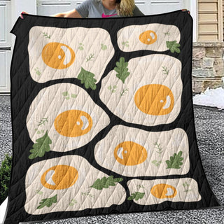 a woman holding up a quilt with oranges on it