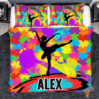 a bed with a colorful bed cover with a picture of a ballerina on it