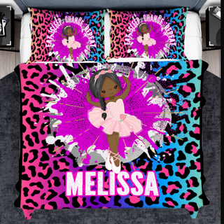 a bed with a pink and blue leopard print and a ballerina on it