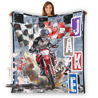 a woman holding a blanket with a painting of a motorcyclist on it