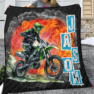 a woman holding up a blanket with a picture of a motorcyclist on