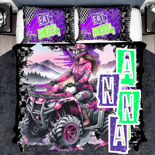 a bed with a pink and purple bed cover and a pink and purple atv