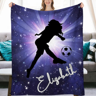 a woman holding a blanket with a picture of a soccer player